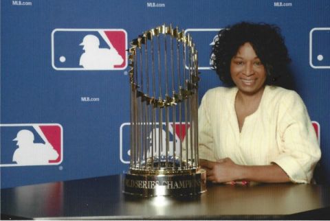 Ruth J. Morrison with Major League Baseball&#039;s World Series trophy