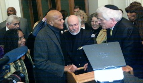 Actor Harry Belafonte (left) and social relevant photographer, Stephen Somerstein (center), overwhelmed by reception guests after giving opening remarks to mark the opening of Somerstein's exhibit, "The 1965 March: Freedom’s Journey from Selma to Montgomery" at the New York Historical Society