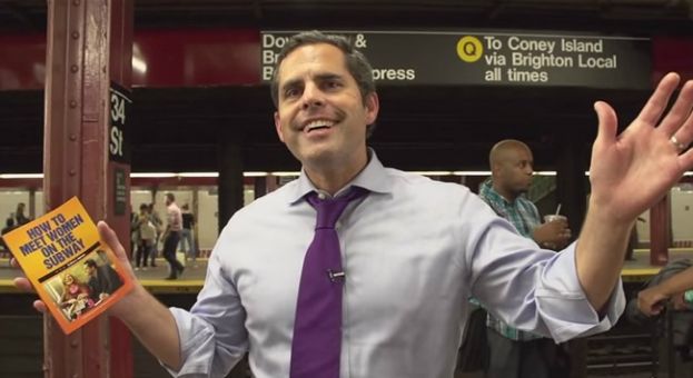 Brian Robinson, author of How to Meet Women in the Subway, with his new book on the Q Train platform at 34th Street in New York City