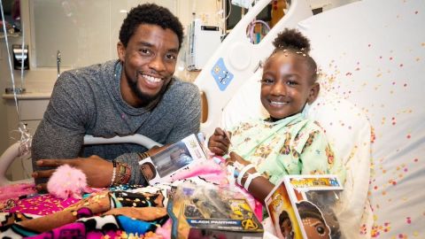 Actor,Chadwick Boseman, succumbs to colon cancer at age 42. In this photo, Boseman brings a smile to a child at St. Jude's hospital.