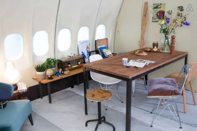 Office/Dining Area inside converted KLM airplane listed on Airbnb