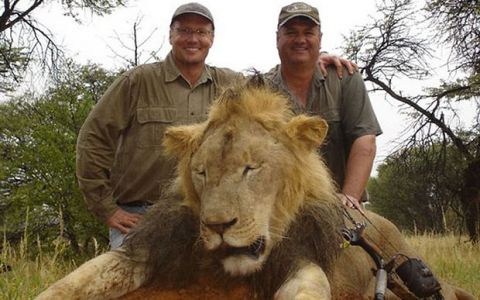 Dr. Walter Palmer, an American poacher, standing over Cecil the Lion, one of Zimbabwe's black mane lions